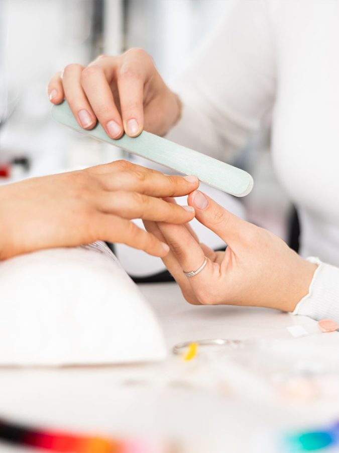 Beautiful hairstyle of young woman after dyeing hair and making highlights in hair salon.