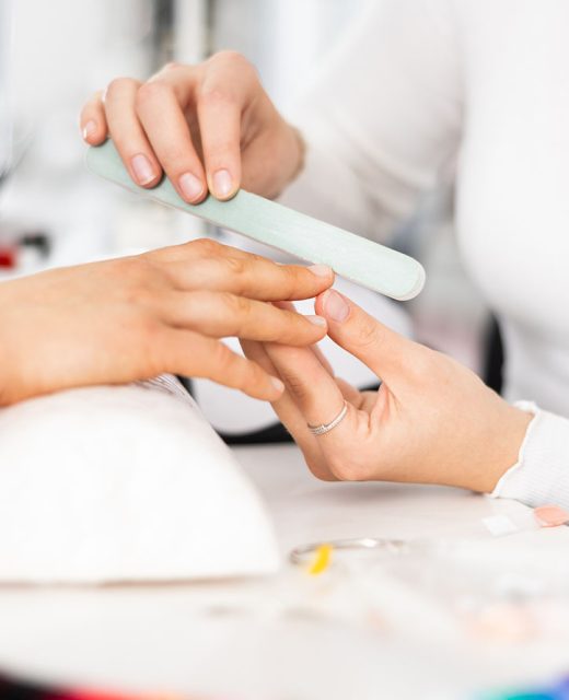 Beautiful hairstyle of young woman after dyeing hair and making highlights in hair salon.